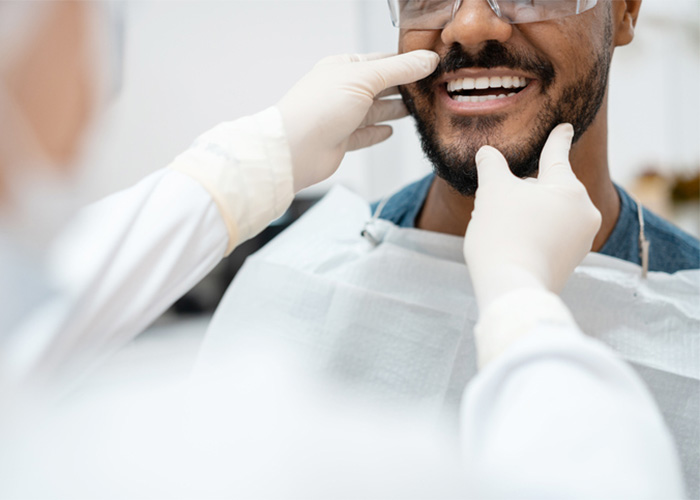 A dentist examines a patient's teeth